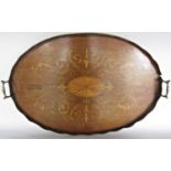 An oval Edwardian mahogany tray with satinwood inlaid decoration and galleried edge, 66cm x 43cm.