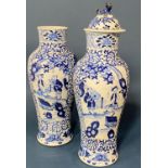 Pair of Chinese blue and white porcelain baluster vases (Qing period), one missing cover, both