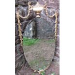 A oval mirror with bevelled edge plate and gilt highlighted raised urn swag and harebell detail 90cm