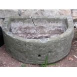 A weathered natural stone D shaped trough 61 cm wide x 48 cm deep x 23 cm high (af)