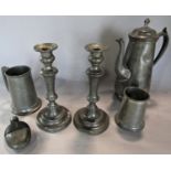 Pewter ware consisting of a coffee pot, two tankards, a pair of candlesticks and a hip flask. 6