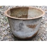 A vintage cast iron cauldron/tub of circular tapered form with flared rim and rounded bottom, 54