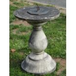 A weathered contemporary sundial of octagonal form with pierced gnomon sat on a weathered cast