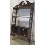 A Chippendale revival mahogany flight of hanging wall shelves with architectural broken swan neck