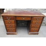 Edwardian oak pedestal desk of nine drawers with inset leather top raised on a plinth base, 122 cm