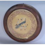 A circular copper and brass engraved Middle Eastern charger with scrolled design and a mother of