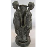 The Three Graces after Clodion a spelter candlestick, 27cm high.