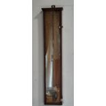 An Admiral Fitzroy's barometer in a plain timber case with original paper backing, thermometer, etc