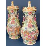 Pair of Chinese famille rose mandarin vases and covers, Qing period, of quatrefoil form, with