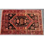 A Zanjan rug with a central geometric motif with radiating stylised flowers, 215cm x 130cm approx