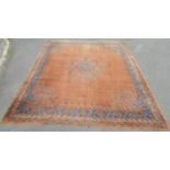A large Qashgai carpet with a rusty red ground interspersed with medallions, 370cm x 310cm