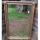 A 19th century gilt framed mirror, the repeating geometric detail and rams mask borders, 62 cm x