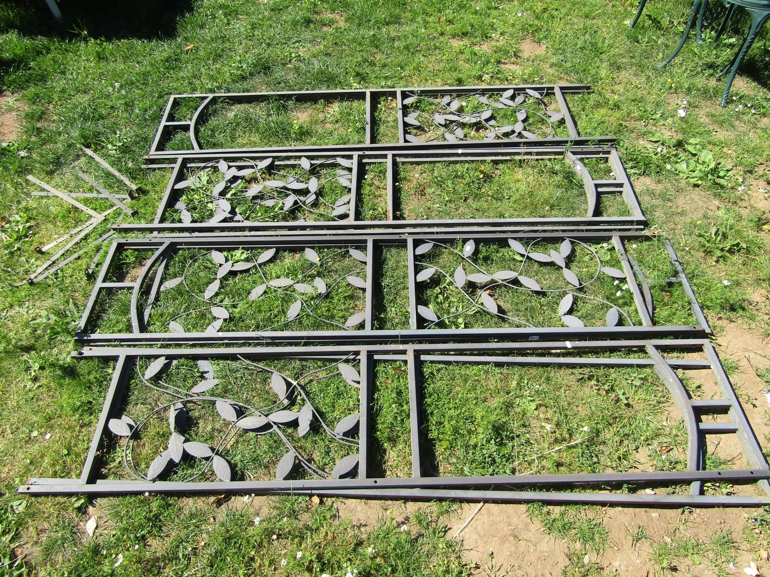 A run of seven contemporary coated cast aluminium garden panels with decorative scrolling vine