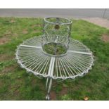 A contemporary cast aluminium sectional tree seat with open scroll and repeating loop and foliate