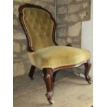 A Victorian ladies drawing room chair the upholstered seat with serpentine outline and button back