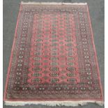 A Turkoman carpet with an overall elephant foot pattern on a pink ground,191cm x 127cm