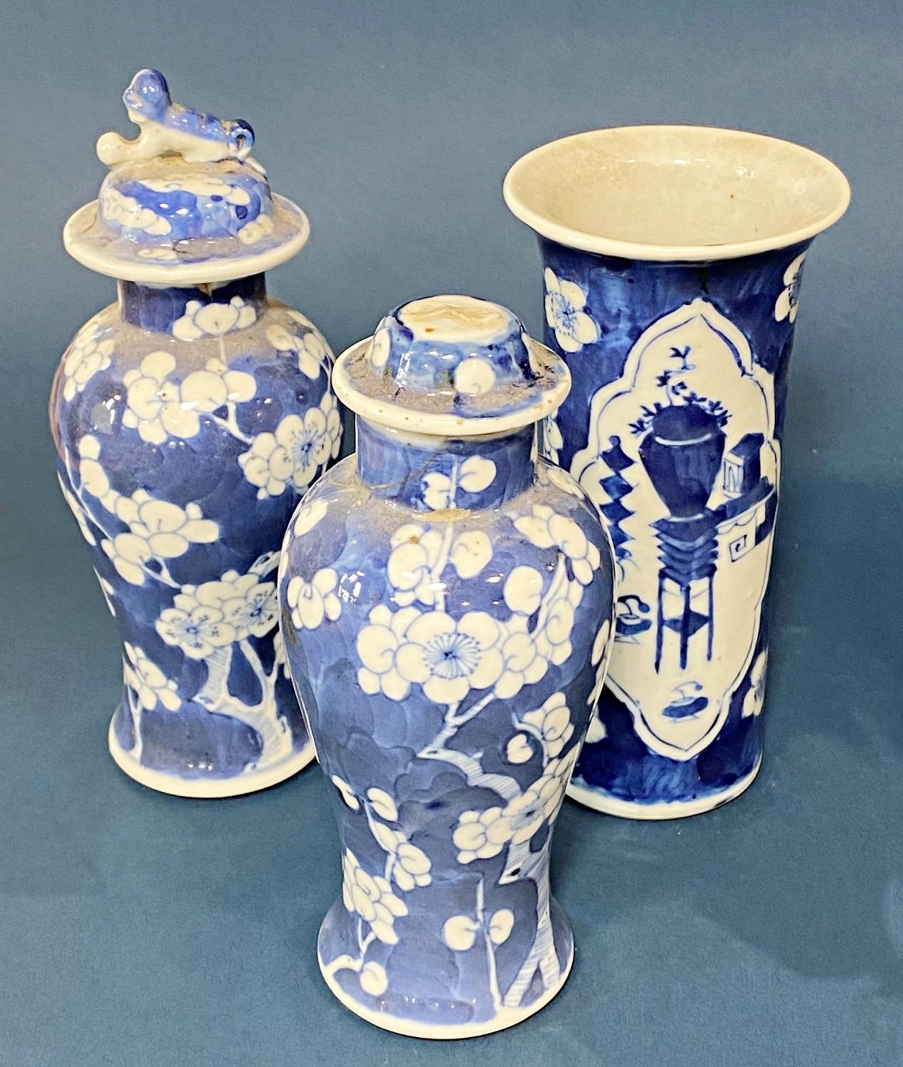 Two Chinese blue and white porcelain prunus vases with covers and brush pot (Qing period) to