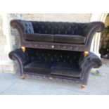 A graduated pair of Clive Christian Chesterfield sofas produced to mark the Diamond Jubilee of 2012,