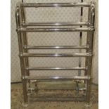 A good quality floorstanding tubular chromium steel framed heated towel rail with twin tap, 57 cm