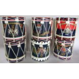 Seven ice buckets in form of Military Drums, including The Royal Army of Ordnance, Royal Navy, Royal