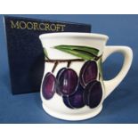 A Moorcroft Pottery 'Plum' pattern mug, designed by Sally Tuffin for Liberty, 9cm tall approx, stamp
