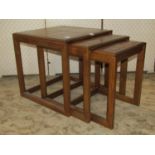 A nest of three graduated G-Plan oak occasional table, with segmented square panelled tops raised on