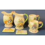 A collection of Crown Devon ware comprising two jugs with relief moulded detail, Daisy Bell,