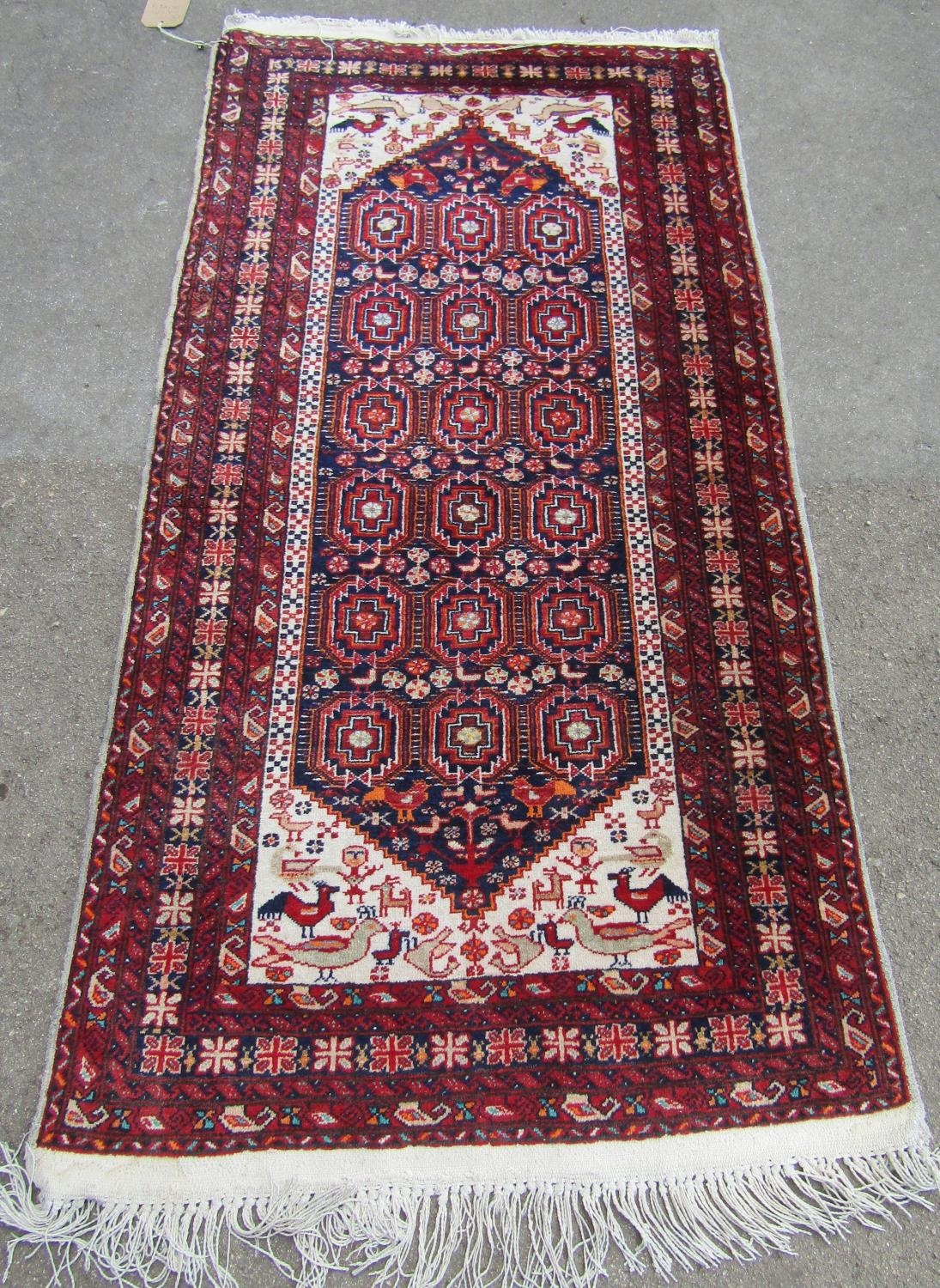 A mid 20th century Beloudj rug with a geometric central diamond shaped medallion with stylised