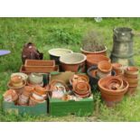 A quantity of approximately 50 plus terracotta flower pots of varying size, carp ornament, small