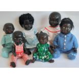 Six vintage black baby dolls including a British made all composition doll with painted features,
