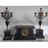 A Victorian clock garniture, the clock in a reeded architectural case with black dial and gold