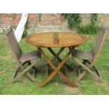 A contemporary Royal Craft stained hardwood circular folding garden table with slatted panelled