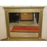 A rectangular overmantle mirror enclosing a bevelled edge mirror plate, the gilded frame with reeded