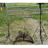 A pair of weathered strapwork wall mounted flower baskets, two circular hanging baskets, a plant