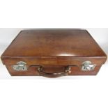 A vintage leather suitcase, with decent handle and stitching, working clasps initialled I.M.C , 56cm