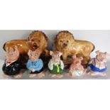 A Wade Nat West family of pigs, and a pair of large Staffordshire Style Lions with beaded eyes, 29cm