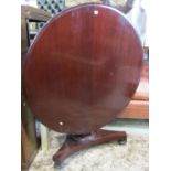 Victorian mahogany tea table with circular top raised on a tapering hexagonal pillar and tricorn