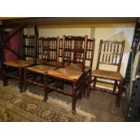 Seven Georgian ashwood spindle back dining chairs, all with rush seats on turned supports