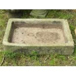 A weathered natural stone trough of shallow rectangular form 75 cm long x 51 cm wide x 14 cm deep