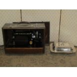 A vintage Singer sewing machine in travelling case together with a Victorian silver plated entre