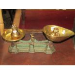 A pair of vintage cast iron kitchen balance scales by H Pooley & Son, Birmingham with brass pans,
