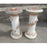 A pair of painted and distressed glass fibre columns with trailing floral detail, 75cm high
