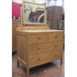 Pale oak dressing chest of two long and two short drawers, with raised mirror back, almost certainly