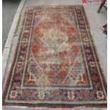 A faded early 20th century Djoshegan carpet with a central diamond medallion, 205cm x 130cm.