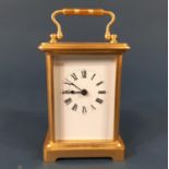 A Simple brass carriage clock enclosing an eight day time piece