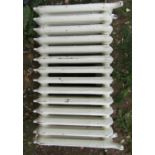 A pair of reclaimed good quality cast iron floorstanding radiators with scrolling foliate detail and