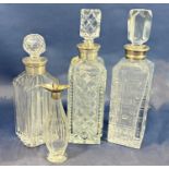 An early 20th century vinaigrette bottle with a silver collar, and three cut glass decanters with