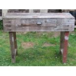 Two vintage pine work benches of varying size, one incorporating a frieze drawer, the larger example
