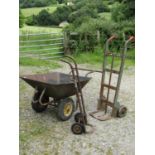 A large useful two wheeled wheelbarrow with pneumatic tyres, weathered metal body and tubular handle