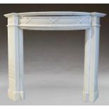 A Georgian style white marble fire place with a curved mantle on reeded square column legs. Mantel